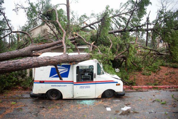 Fallen trees rest on a damaged postal truck at an apartment complex where a reported tornado passed through in Spartanburg, S.C., on Feb. 6, 2020.(Sean Rayford/AP)