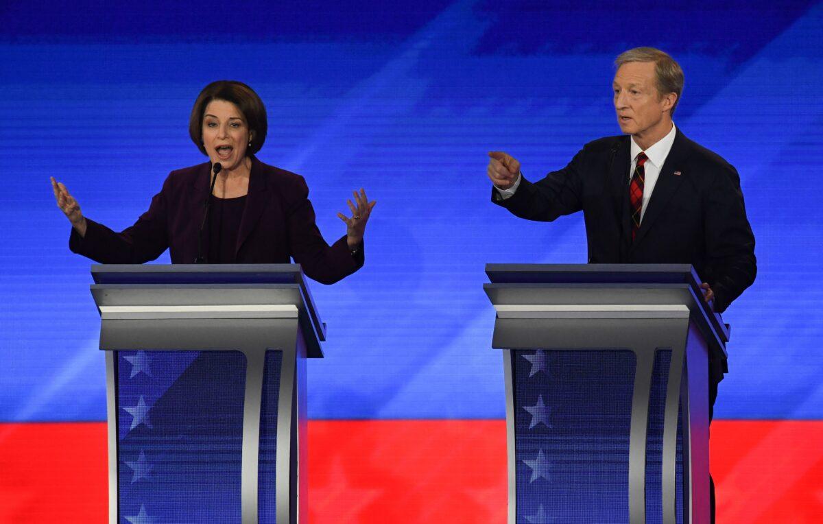 Democratic presidential candidates Sen. Amy Klobuchar (D-Minn.) and businessman Tom Steyer speak during the primary debate in New Hampshire on Feb. 7, 2020. (Timothy A. Clary/AFP via Getty Images)