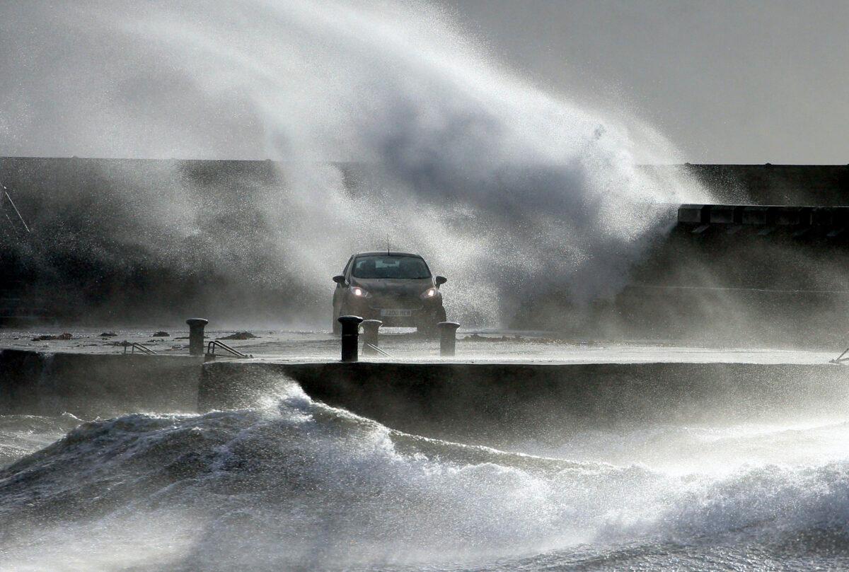 Waves lash the coast on the Ayrshire coast at Ardrossan, Scotland on Sunday, Feb. 9, 2020. (Andrew Milligan/PA via AP)