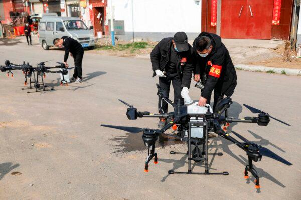 Local residents fills a drone with disinfectant before spraying in a village in Pingdingshan, in China's central Henan Province on Jan. 31, 2020, during the virus outbreak in Hubei's city of Wuhan. (STR/AFP via Getty Images)