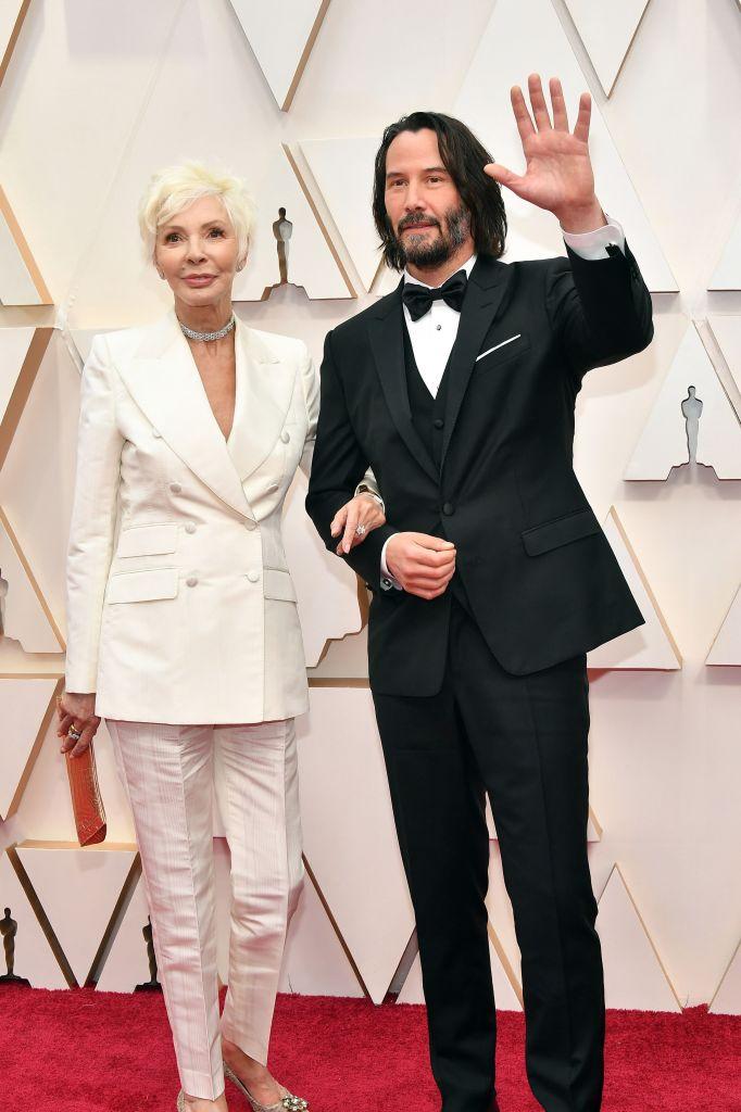 Taylor and Reeves pose for the paparazzi at the 92nd annual Oscars at Hollywood and Highland in Hollywood, California, on Feb. 9, 2020. (©Getty Images | <a href="https://www.gettyimages.com/detail/news-photo/patricia-taylor-and-keanu-reeves-attends-the-92nd-annual-news-photo/1205140895?adppopup=true">Amy Sussman</a>)