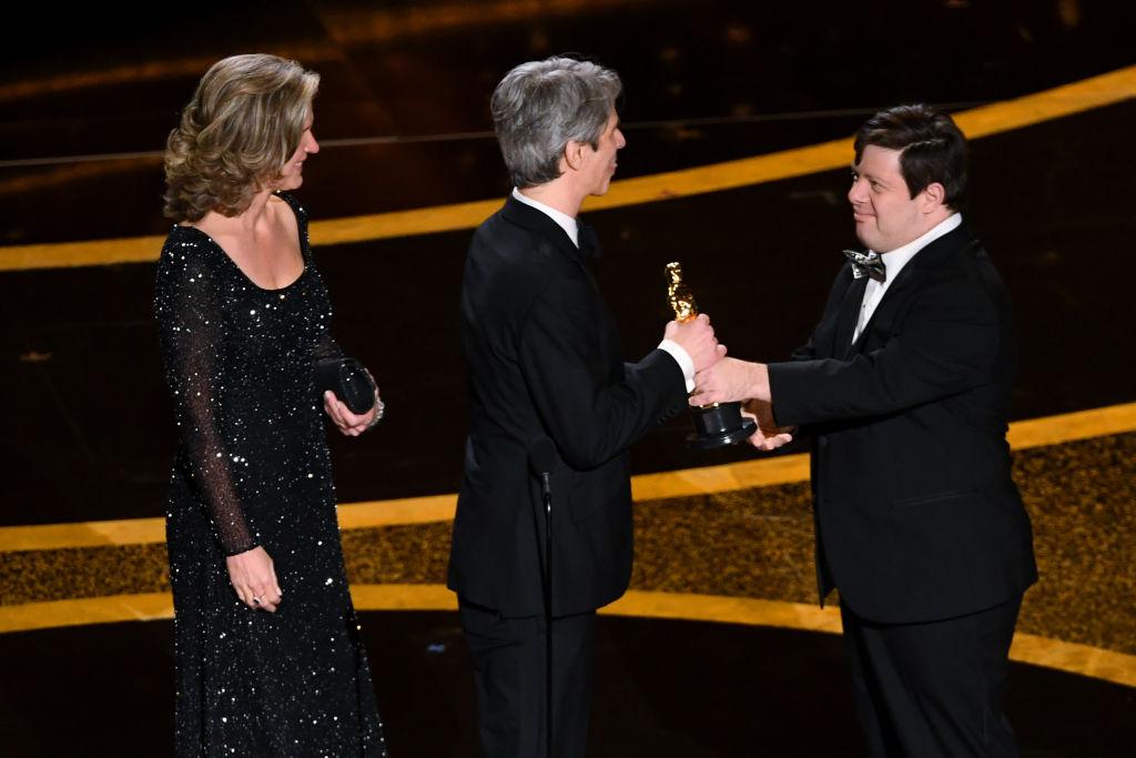 (L–R) Elizabeth Martin and Marshall Curry accept the Best Live Action Short Film award for 'The Neighbors' Window' from Gottsagen onstage at the 92nd annual Oscars in Hollywood, California, on Feb. 9, 2020. (©Getty Images | <a href="https://www.gettyimages.com/detail/news-photo/elizabeth-martin-and-marshall-curry-accept-the-short-film-news-photo/1205152325?adppopup=true">Kevin Winter</a>)