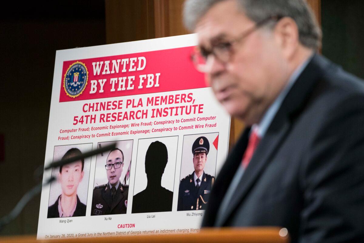 Attorney General William Barr participates in a press conference at the Department of Justice along with DOJ officials on Feb. 10, 2020 in Washington, DC. Barr announced the indictment of four members of China's military on charges of hacking into Equifax Inc. and stealing data from millions of Americans. (Sarah Silbiger/Getty Images)