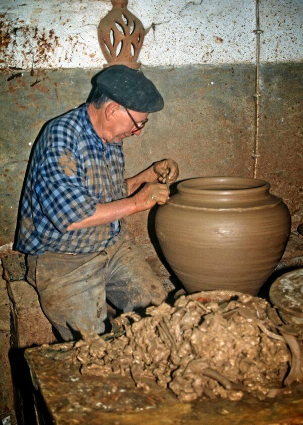 Redondo is famous throughout Portugal for its potteries and plates. Here a potter churns out his wares. (Fred J. Eckert)