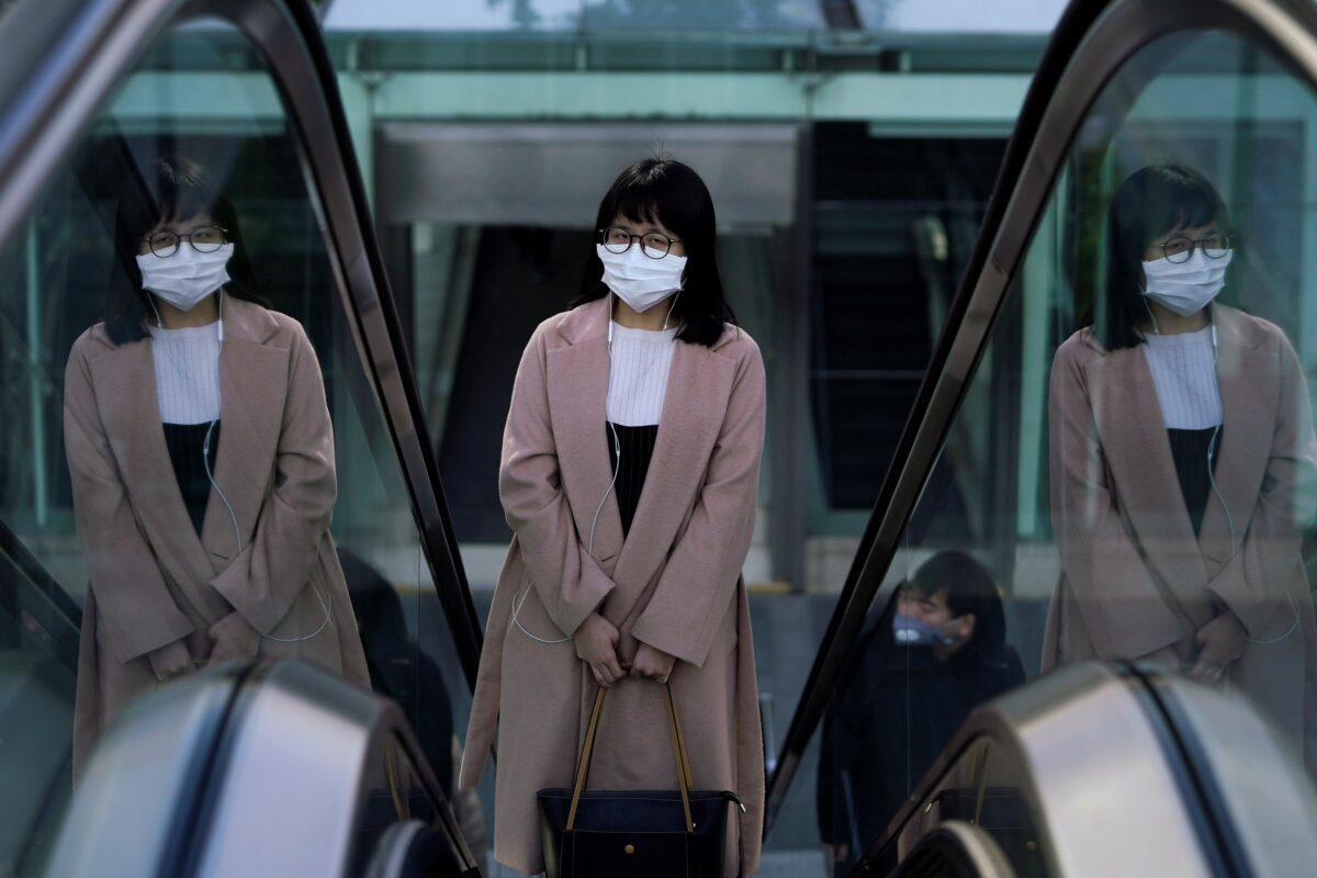 A woman wearing a mask is seen as the country is hit by an outbreak of the novel coronavirus in Shanghai, China February 10, 2020. (Aly Song/Reuters)