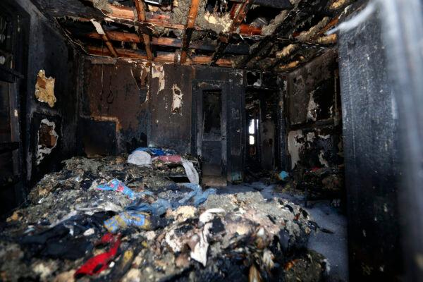 Burned clothes and the interior of a house are destroyed from a fatal fire in Clinton, Miss., on Feb. 8, 2020. (Rogelio V. Solis/AP Photo)