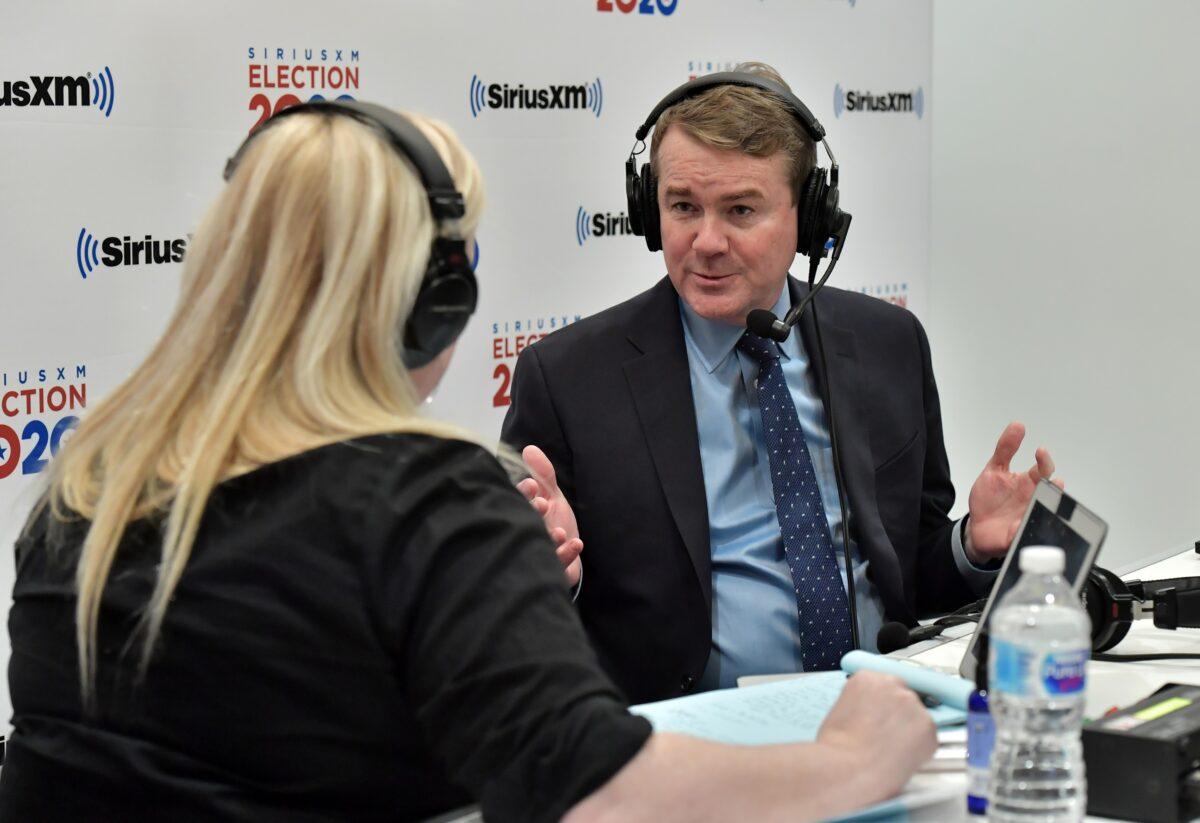 SiriusXM host Julie Mason speaks with Democratic presidential candidate Sen. Michael Bennet (D-Colo.) in Manchester, New Hampshire, on Feb. 10, 2020. (Paul Marotta/Getty Images for SiriusXM)