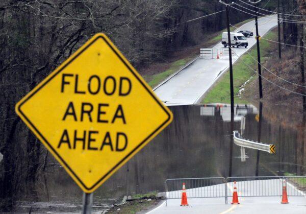 Vehicles turn around on a road blocked by floodwaters in Helena, Ala., on Feb. 11, 2020. (Jay Reeves/AP Photo)