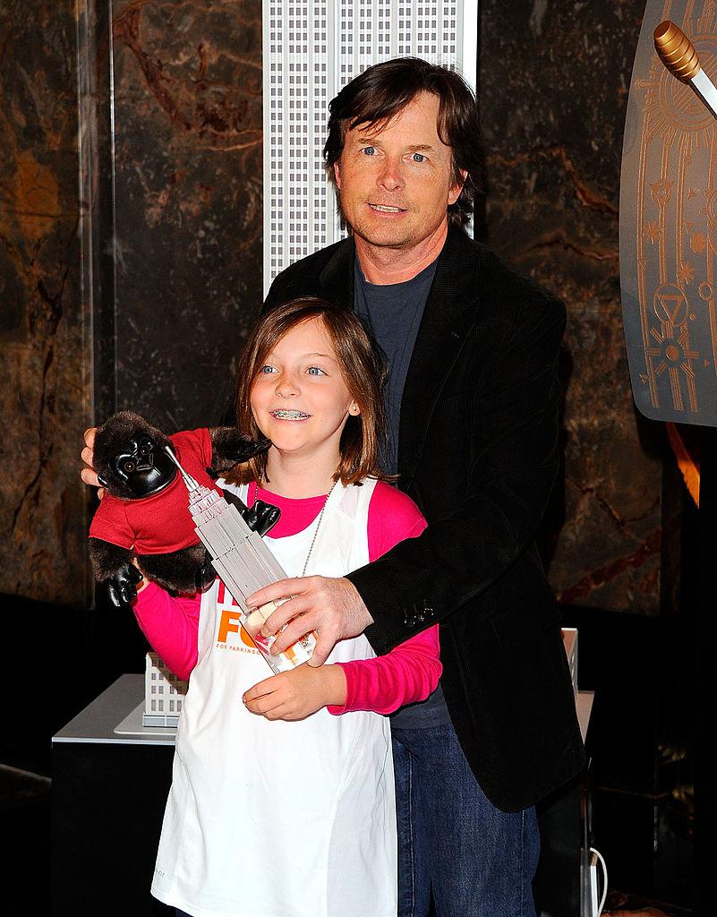 Michael J. Fox and his daughter, Esme, light the Empire State Building to raise awareness for The Michael J. Fox Foundation for Parkinson's Research in New York City on April 8, 2011. (©Getty Images | <a href="https://www.gettyimages.com/detail/news-photo/michael-j-fox-and-his-daughter-esme-fox-light-the-empire-news-photo/111903310?adppopup=true">Andrew H. Walker</a>)