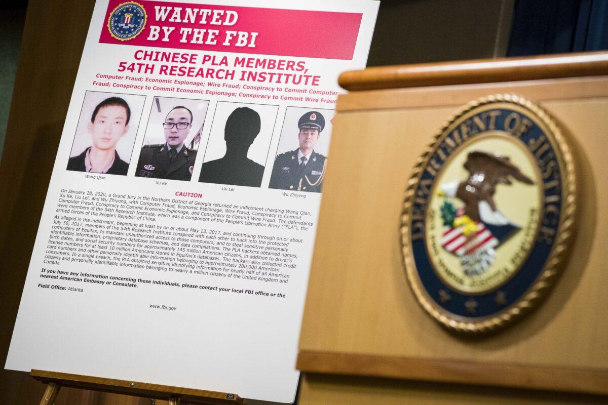 Signs that depict the four members of China's military indicted on charges of hacking into Equifax Inc. and stealing data from millions of Americans are seen at the Department of Justice in Washington on Feb. 10, 2020. (Sarah Silbiger/Getty Images)