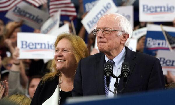Democratic presidential hopeful Vermont Senator Bernie Sanders (I-Vt.) arrives, flanked by his wife Jane O'Meara Sanders, to speak at a Primary Night event at the SNHU Field House in Manchester, New Hampshire, on Feb. 11, 2020. (Timothy A. Clary/AFP via Getty Images)
