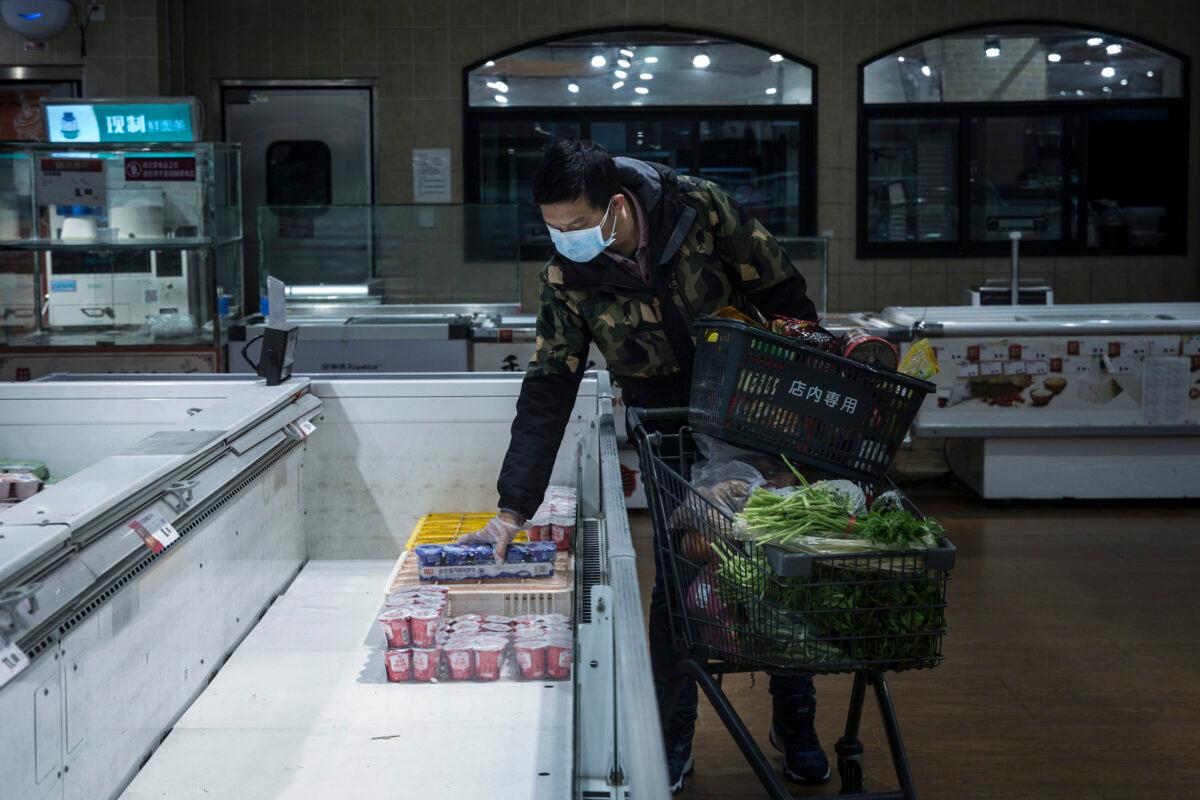 Resident shops in the almost empty supermarket in Wuhan, China, on Feb. 12, 2020. (Stringer/Getty Images)