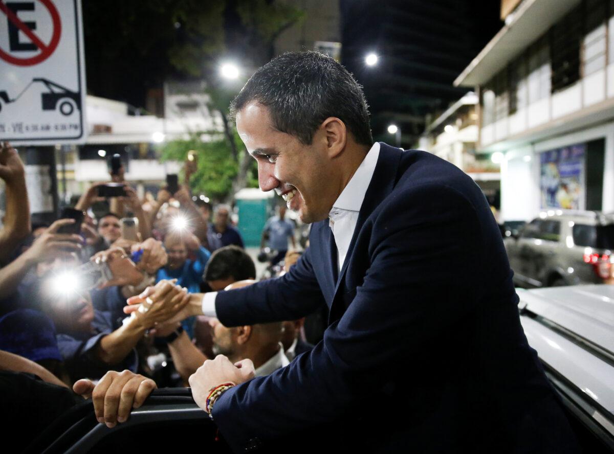 Venezuela's opposition leader Juan Guaidó, who many nations have recognized as the country's rightful interim ruler, greets supporters as he arrives at a meeting in Caracas, Venezuela, on Feb. 11, 2020. (Manaure Quintero/Reuters)