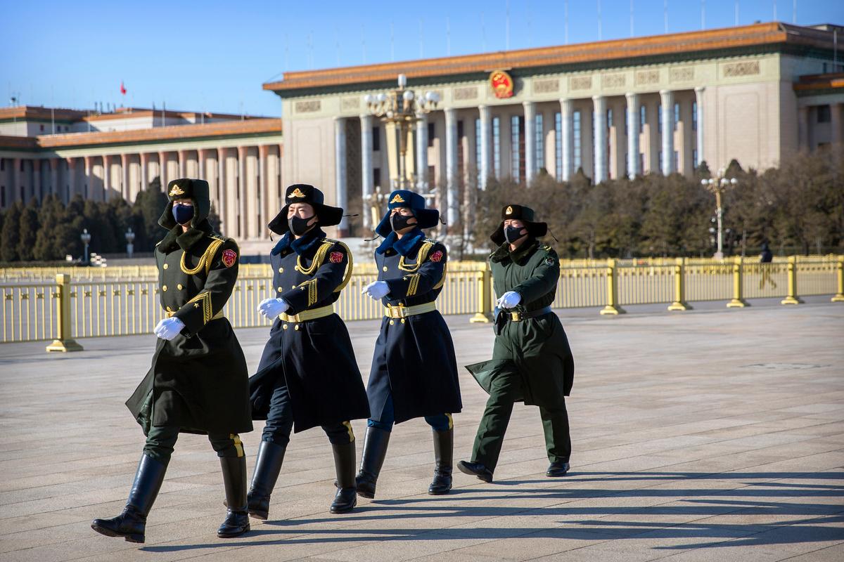 Chinese honor guard wear face masks as they march in formation near the Great Hall of the People on Tiananmen Square in Beijing on Feb. 4, 2020. (Mark Schiefelbein/AP)