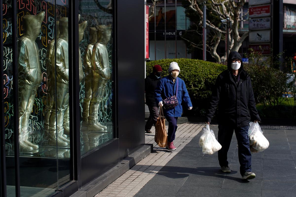 People wearing masks are seen at a shopping mall in downtown Shanghai, China, as the country is hit by an outbreak of a new coronavirus on Feb. 12, 2020. (Aly Song/Reuters)