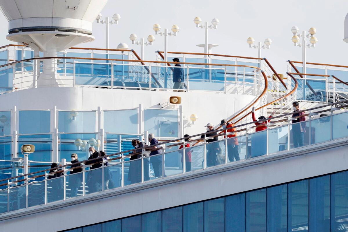 Passengers stand on the deck of the Diamond Princess cruise ship anchored at Yokohama Port in Yokohama on Feb. 12, 2020. (Yuta Omori/Kyodo News via AP)