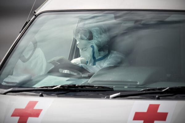 An emergency worker in protective clothing drives an ambulance carrying a person diagnosed with COVID-19 in Yokohama, Japan on Feb. 13, 2020. (Carl Court/Getty Images)