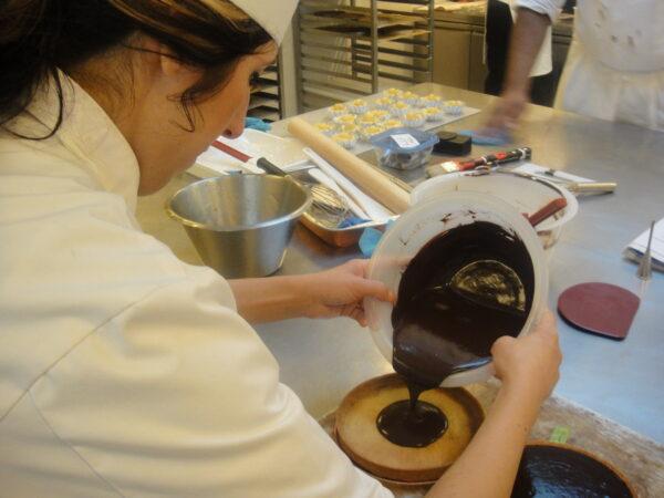 Christina Ferrari pours a mixture from a bowl as she prepares a dish. (Christina Ferrari)