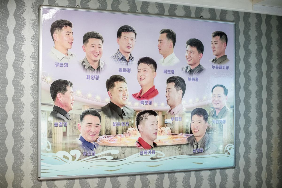 A board showing approved hairstyles is displayed at a men's salon in the Munsu Water Park complex on Aug. 19, 2018, in Pyongyang, North Korea. (Carl Court/Getty Images)