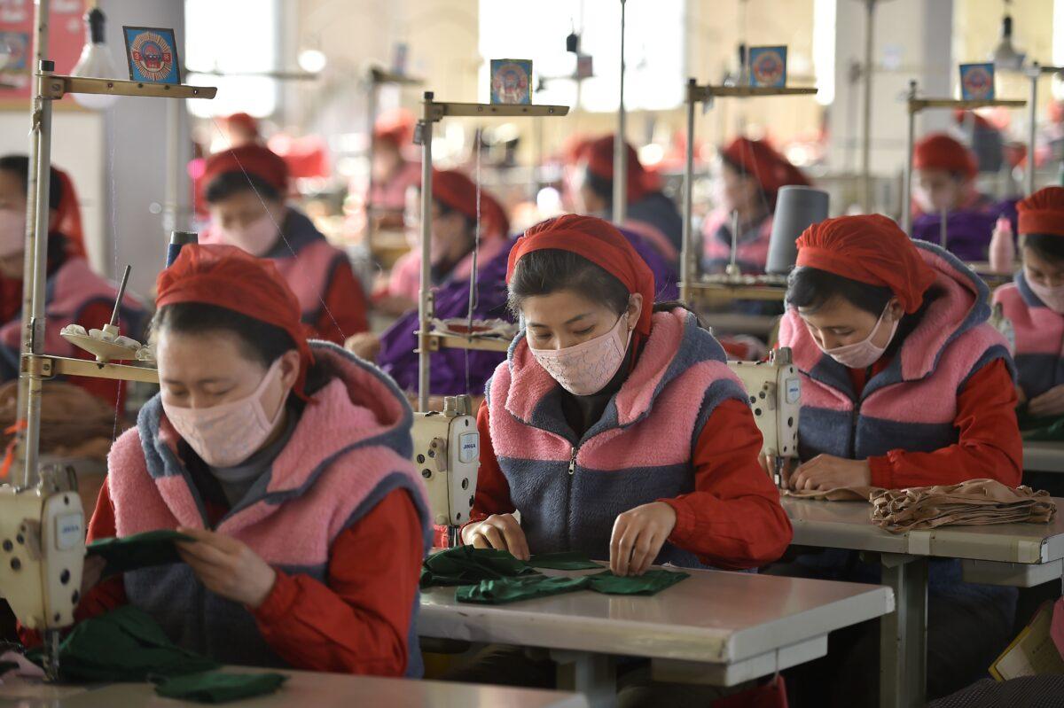 Workers of Songyo Knitwear Factory in Pyongyang produce masks for protection against the new coronavirus.. (Kim Won-Jin/AFP via Getty Images)