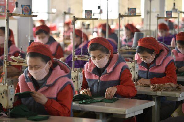 Workers of the Songyo Knitwear Factory produce masks for protection against the new coronavirus in Pyongyang on Feb. 6, 2020. (Kim Won-Jin/AFP via Getty Images)