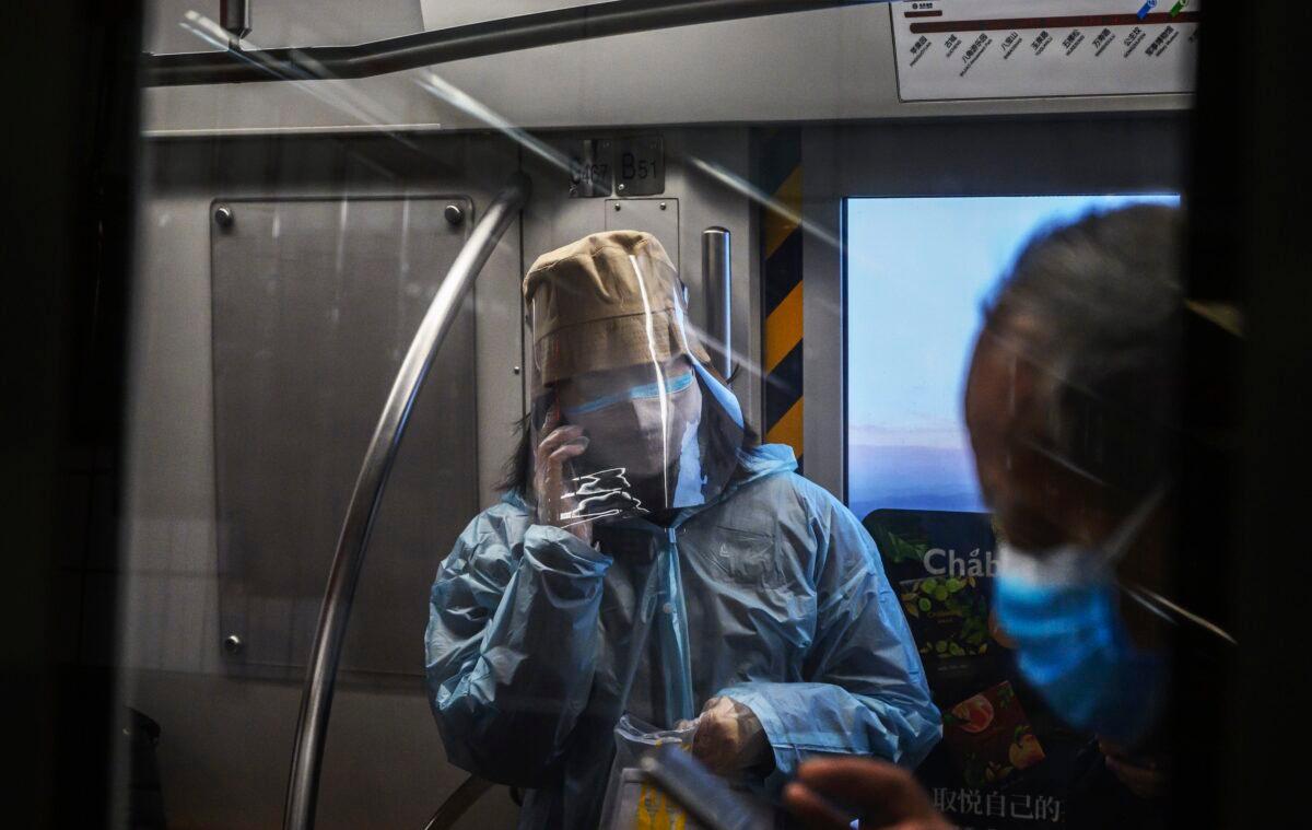 A Chinese woman wears a protective mask and face shield as she rides the subway during rush hour in Beijing, China on Feb. 14, 2020. (Kevin Frayer/Getty Images)
