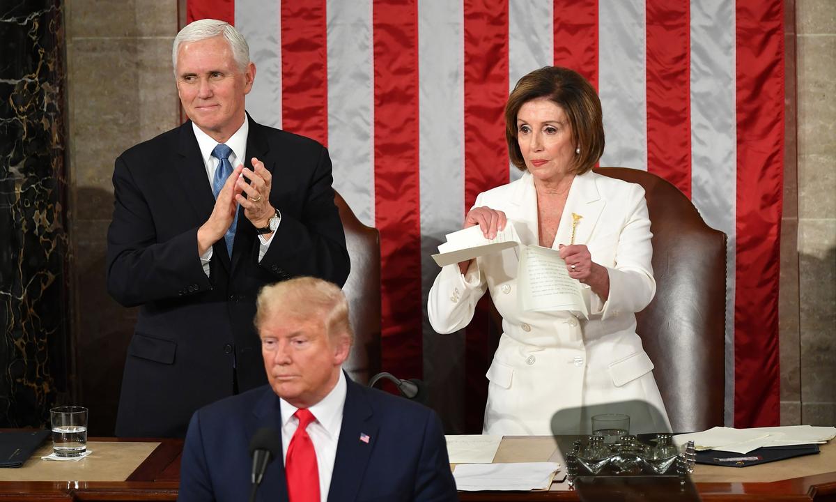 Vice President Mike Pence claps as Speaker of the House of Representatives Nancy Pelosi (D-Calif.) rips a copy of President Donald Trump speech after he delivers the State of the Union address at the Capitol in Washington on Feb. 4, 2020. Mandel Ngan/AFP via Getty Images