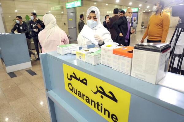 Egyptian Quarantine Authority employees prepare to scan body temperature for incoming travelers at Cairo International Airport on Feb. 1, 2020. (AFP via Getty Images)