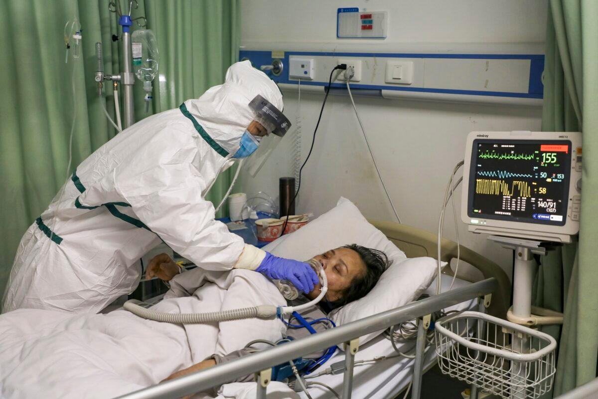 A nurse cares for a patient in the isolation ward for 2019-nCoV patients at a hospital in Wuhan in central China's Hubei Province on Feb. 6, 2020. (Chinatopix via AP)