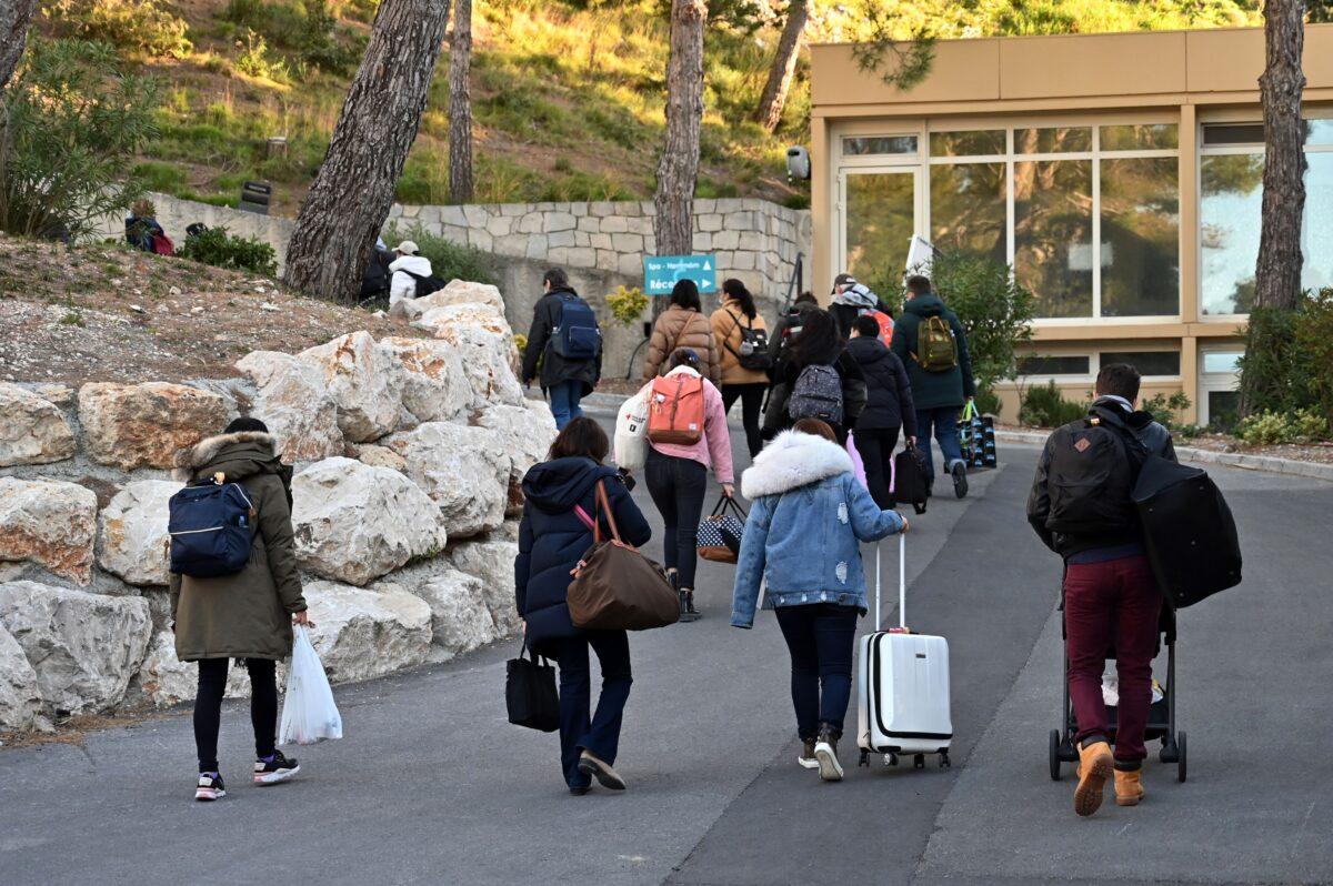 French citizens leave The Vacanciel Holiday Resort in Carry-le-Rouet, near Marseille, southern France on Feb. 14, 2020, where they spent 14 days in quarantine after their repatriation from Wuhan, China. (Hector Retamal/AFP via Getty Images)