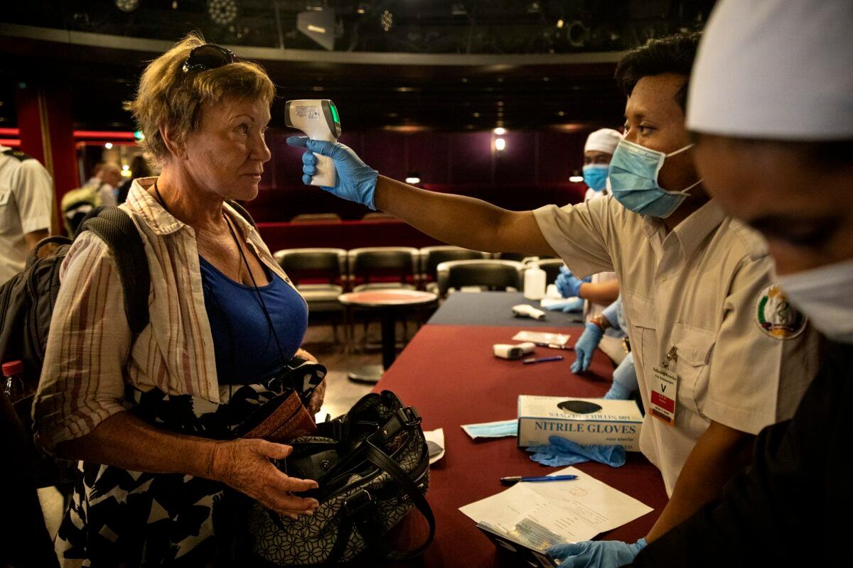 Passengers waiting to travel home get a last health screening before disembarking from the MS Westerdam cruise ship in Sihanoukville, Cambodia, on Feb. 15, 2020. (Paula Bronstein/Getty Images)