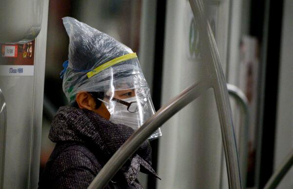 A subway passenger wears a face mask among other protective items in Shanghai on Feb. 12, 2020. (NOEL CELIS/AFP via Getty Images)