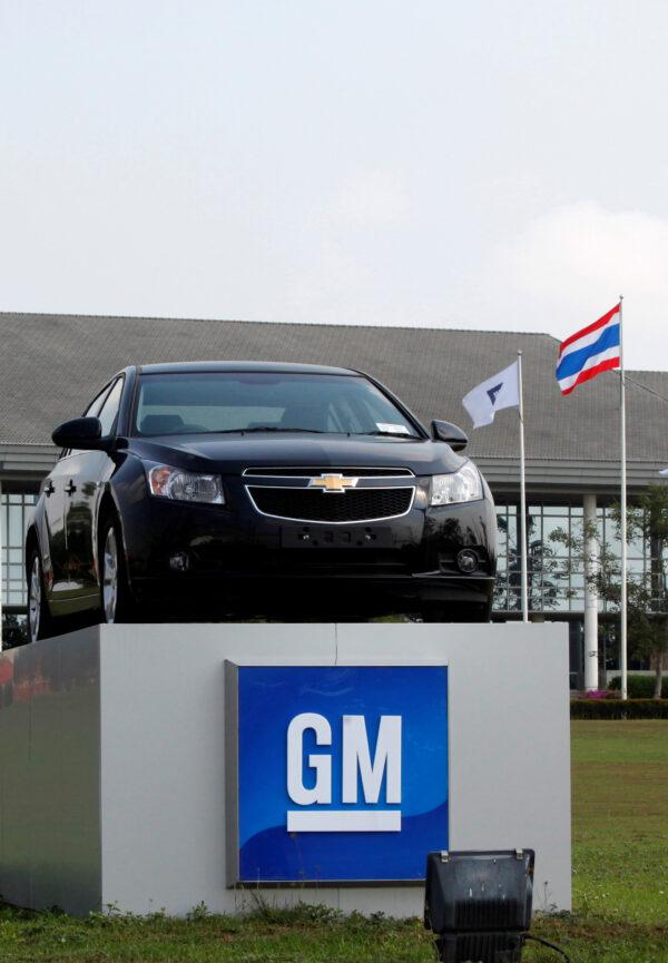 The Thai national flag and a car are displayed in front of the General Motors plant in Rayong province, Thailand, on Feb. 22, 2011. (Chaiwat Subprasom/File Photo/Reuters)