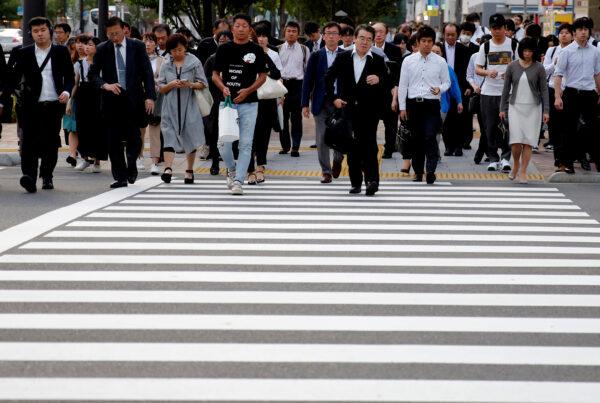 Pedestrians make their way in a business district in Tokyo on May 16, 2018. (Kim Kyung-Hoon/File Photo/Reuters)