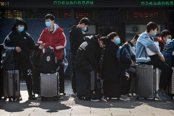 Chinese students wearing safety masks wait to board a train after the Chinese New Year break in Beijing on Jan. 31, 2020. (Kevin Frayer/Getty Images)