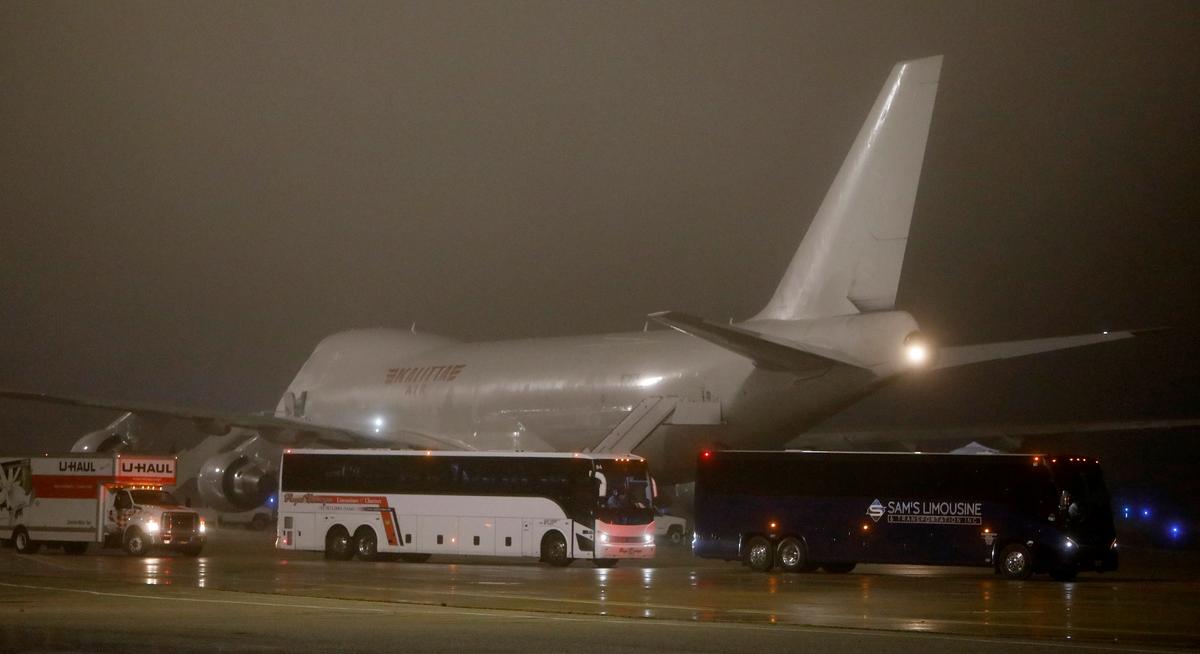 Buses carrying American evacuees from the Diamond Princess cruise ship leave the runway at Joint Base San Antonio-Lackland in San Antonio, Texas, on Feb. 17, 2020. (Edward A. Ornelas/Getty Images)
