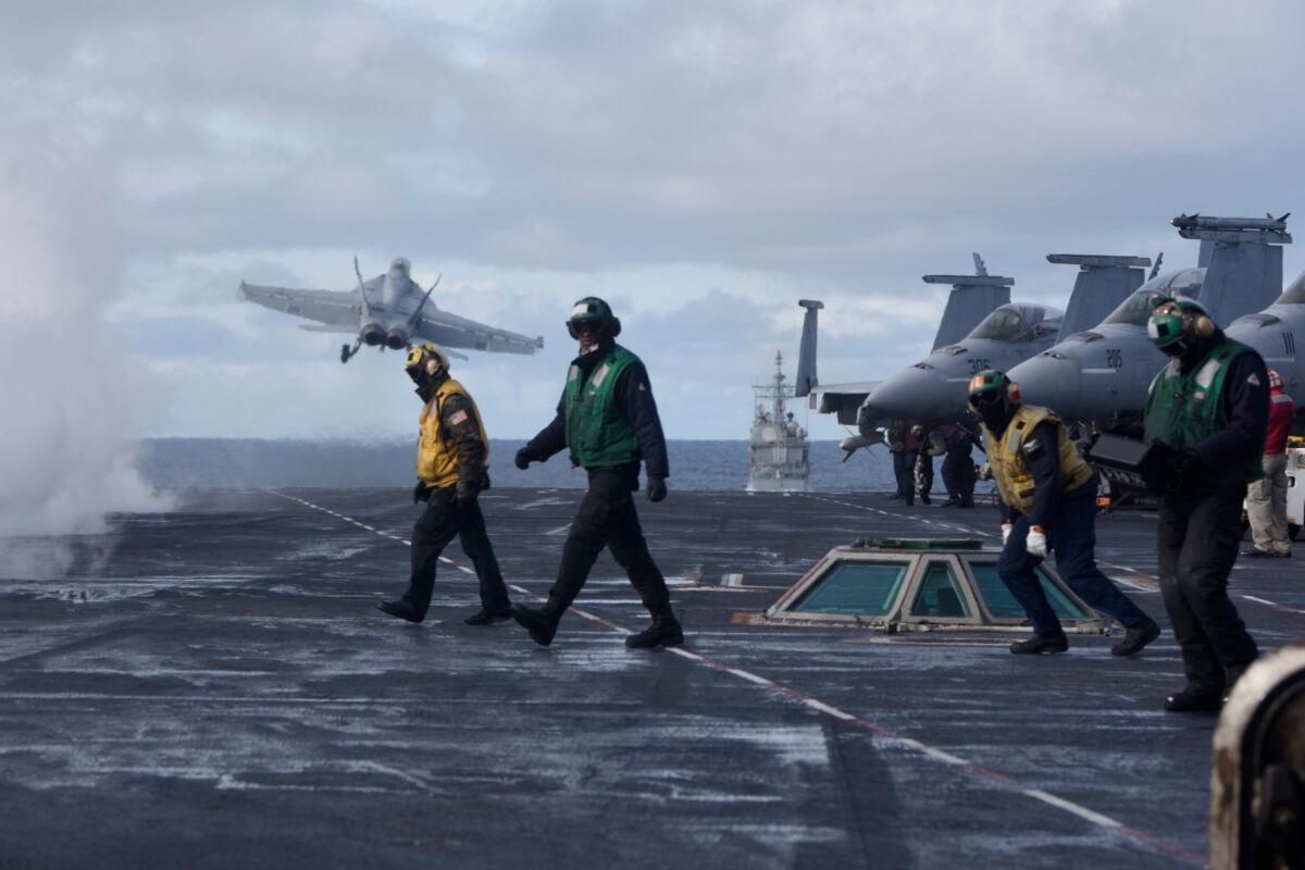 Sailors stand on the flight deck after launching an F/A-18F Super Hornet from the the Nimitz-class aircraft carrier USS Harry S. Truman (CVN 75) in the North Atlantic, on Sept. 18, 2018. (2nd Class Anthony Flynn/DoD)