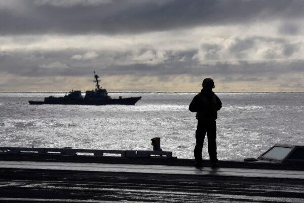 A sailor stands on the flight deck of the Nimitz-class aircraft carrier USS Harry S. Truman during flight operations in the North Atlantic on Sept. 18, 2018. (2nd Class Anthony Flynn/Released/DoD)