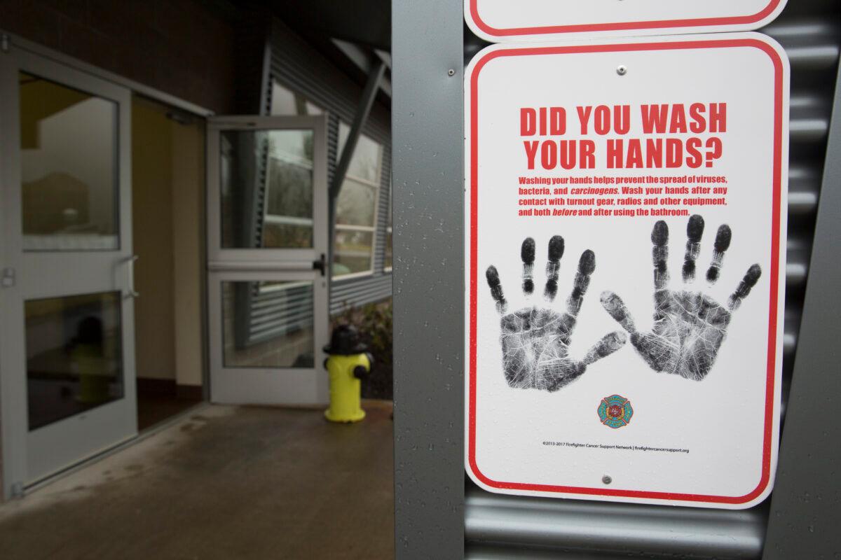 A sign reminding people to wash their hands is pictured outside a dormitory at the Washington State Patrol Fire Training Academy, which has been designated as a Novel Coronavirus quarantine site for travelers from Hubei Province, China, who have been exposed, are not yet symptomatic, and cannot self-quarantine, in North Bend, Washington, on Feb. 6, 2020. (Jason Redmond/AFP via Getty Images)