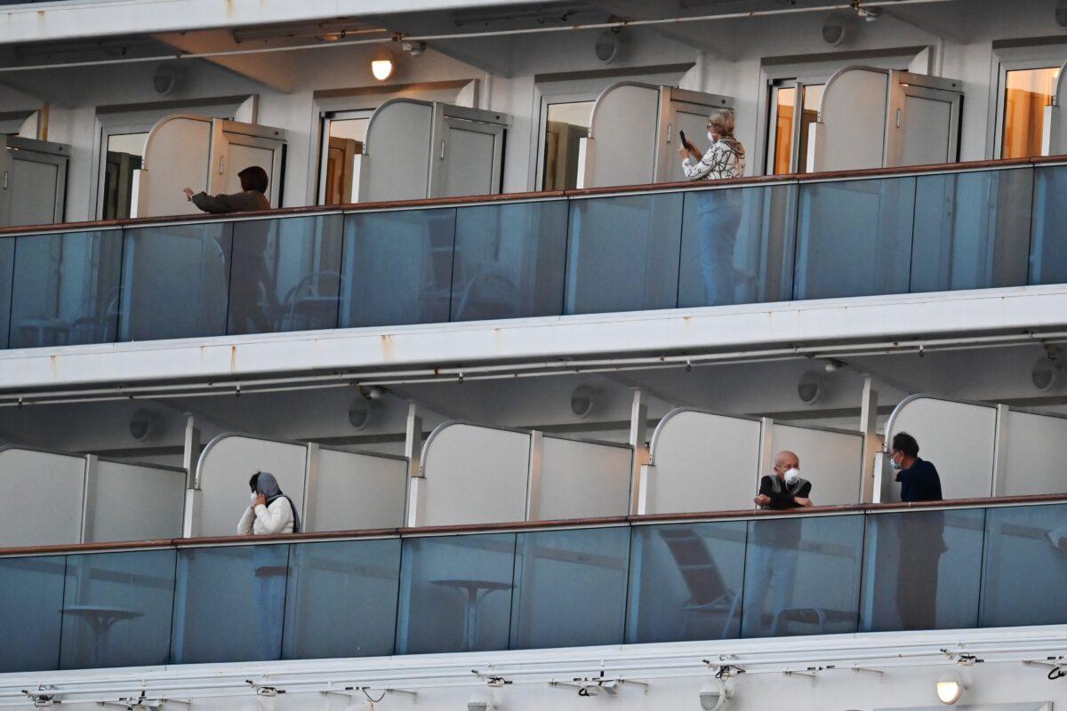 People still in quarantine due to fears of the new COVID-19 coronavirus stand on balconies of the Diamond Princess cruise ship docked at the Daikoku Pier Cruise Terminal in Yokohama, Japan on Feb. 18, 2020. (Charly Triballeau/AFP via Getty Images)