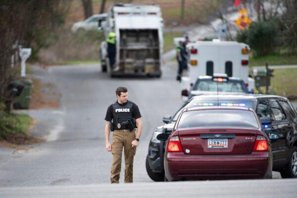 A Cayce police officer approaches a vehicle at a road block near an entrance to the Churchill Heights neighborhood in Cayce, S.C., on Feb. 13, 2020. (Sean Rayford/AP Photo)