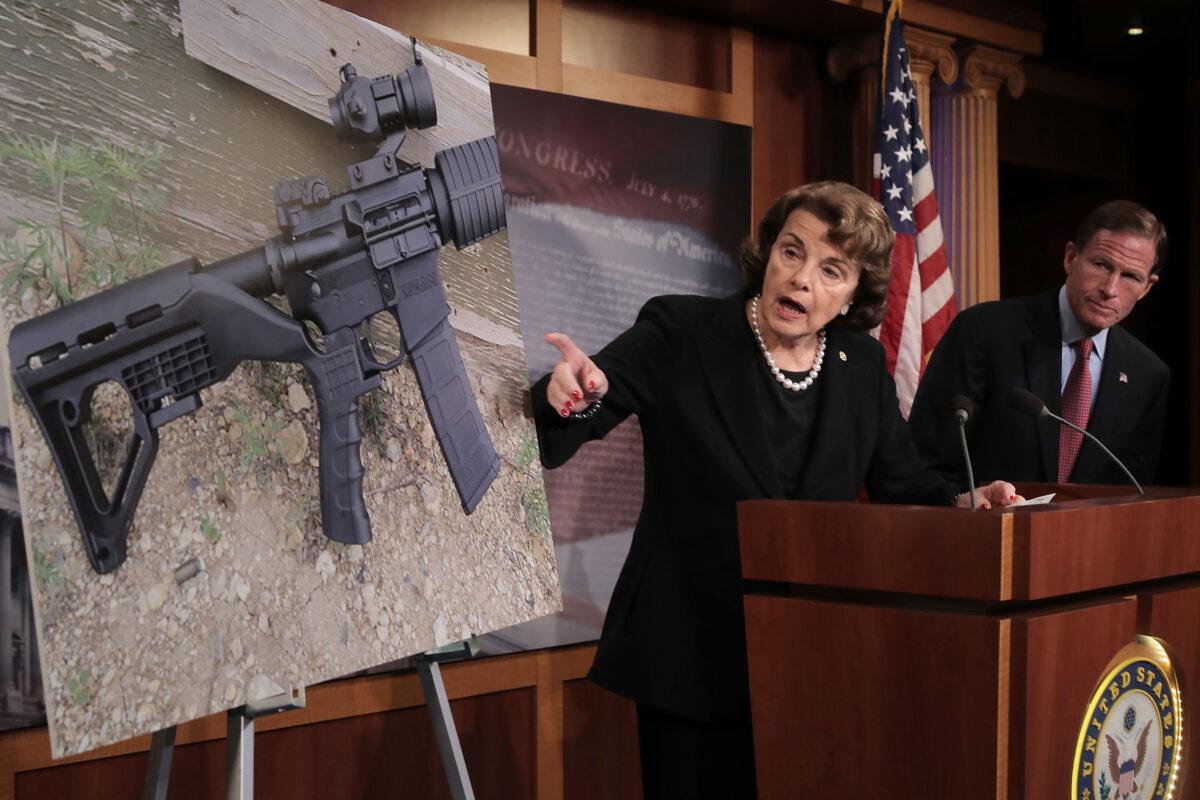 Sen. Dianne Feinstein (D-Calif.), with Sen. Richard Blumenthal (D-Conn.), points to a photograph of a rifle with a bump stock during a news conference to announce proposed gun control legislation at the U.S. Capitol in Washington on Oct. 4, 2017. (Chip Somodevilla/Getty Images)