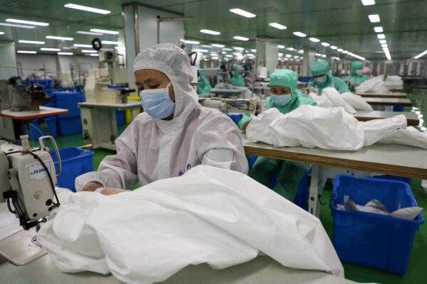 Workers are producing protective suits at a factory in Binzhou city of China's eastern Shandong province on Feb. 13, 2020. (STR/AFP via Getty Images)