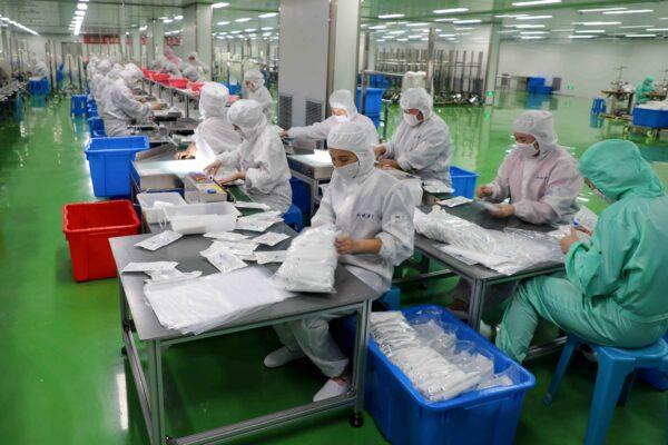 Workers are producing protective suits at a factory in Binzhou city of China's eastern Shandong province on Feb. 13, 2020. (STR/AFP via Getty Images)