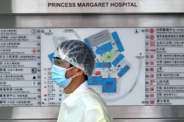 A medical worker wearing protective gear walks outside Princess Margaret Hospital in Hong Kong on Feb. 4, 2020. (Anthony Wallace/AFP via Getty Images)