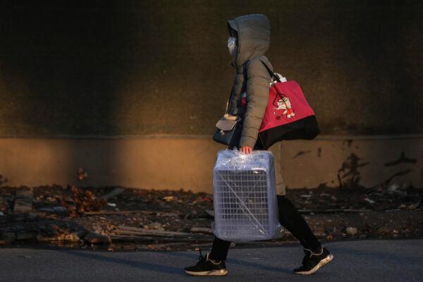A woman wears a protective mask as she carries an empty basket at Optical Valley in Wuhan, China, on Feb. 16, 2020. (Getty Images)