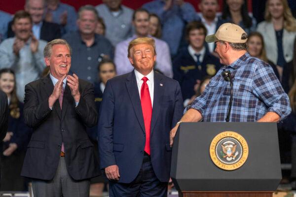 A farmer praises President Donald Trump as House Minority Leader Kevin McCarthy looks on during a legislation signing rally with local farmers in Bakersfield, California, on Feb. 19, 2020. (David McNew/Getty Images)