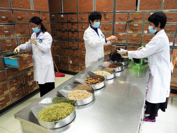 Medical workers prepare traditional Chinese medicine (TCM) at a TCM hospital as the country is hit by an outbreak of the new coronavirus, in Binzhou, Shandong province, China, on Feb. 5, 2020. (cnsphoto via Reuters)