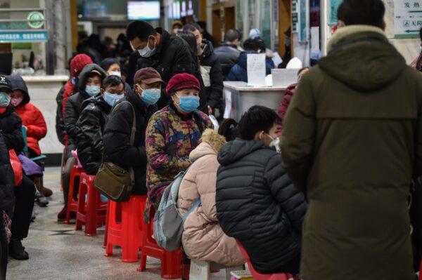 People wearing facemasks as they wait at the Wuhan Red Cross Hospital in Wuhan on Jan. 24, 2020. (Hector Retamal/AFP via Getty Images)