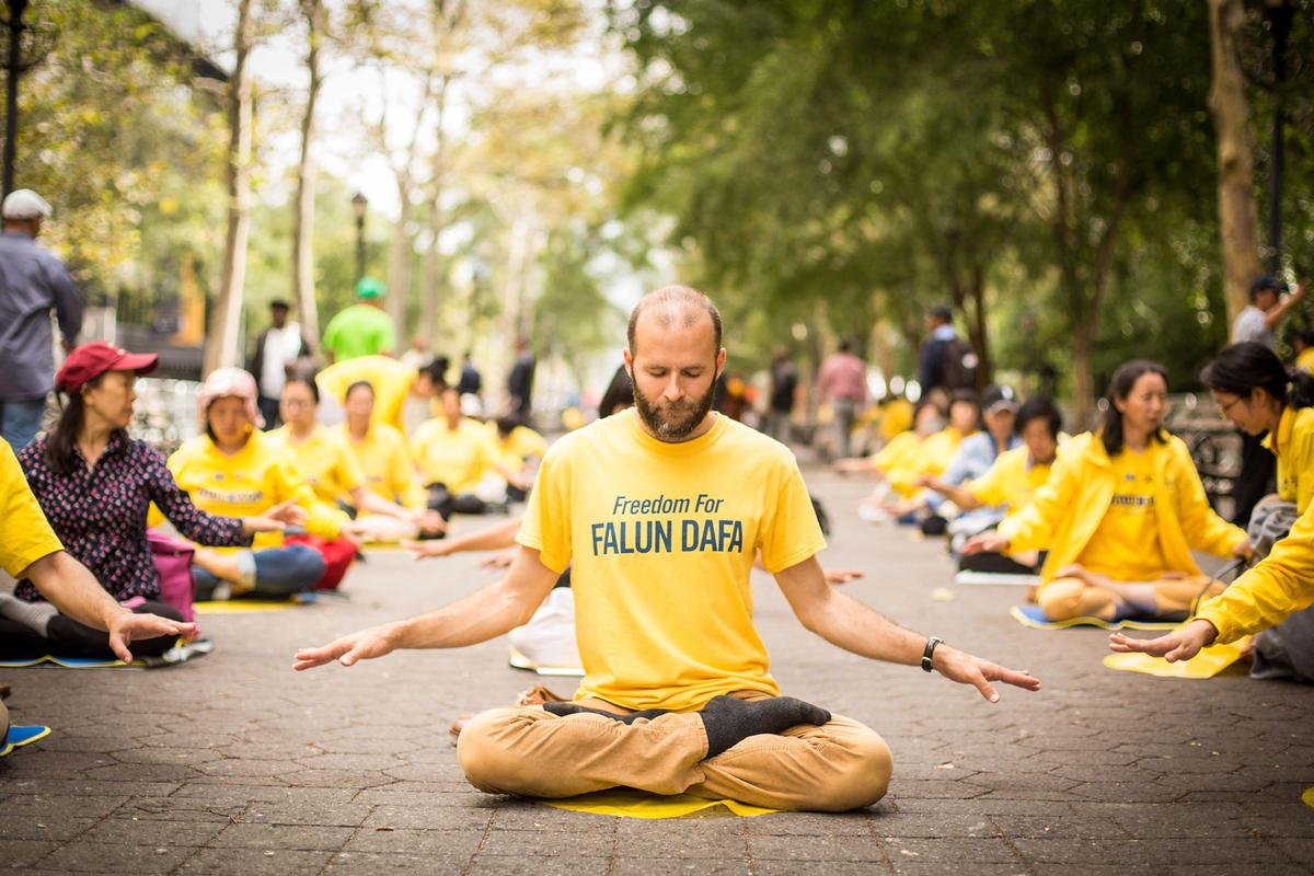 Nemanja practicing the fifth exercise of Falun Dafa. (Benjamin Chasteen/The Epoch Times)
